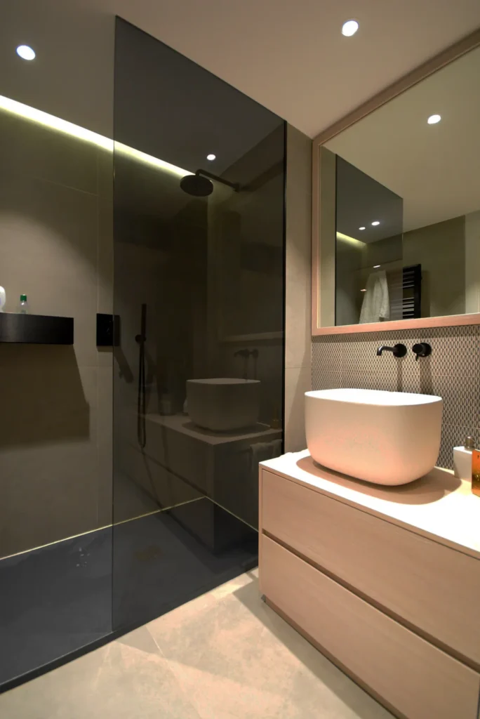 Sleek modern bathroom with vessel sink and walk-in shower by Bathroom Renovations Kapiti