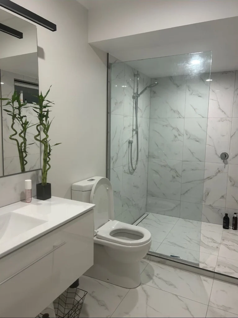 Renovated bathroom with walk-in shower by Bathroom Renovations Kapiti