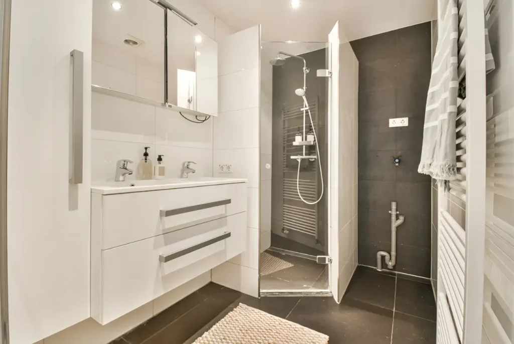 Happy client reviewing a completed bathroom renovation by Bathroom Design Kapiti, showcasing quality service and satisfaction.
